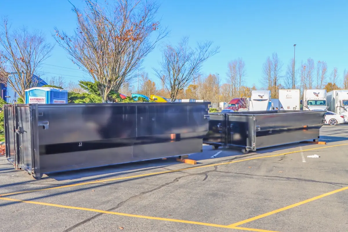 Professional dumpster rental service with roll-off container on residential driveway in Ponca City